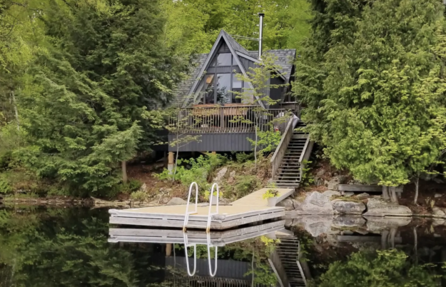 A-frame cottage and dock on a lake